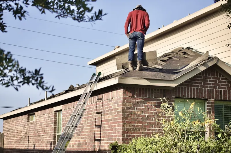 Professional roofer working on a residential roof in Errol Estates Country Club